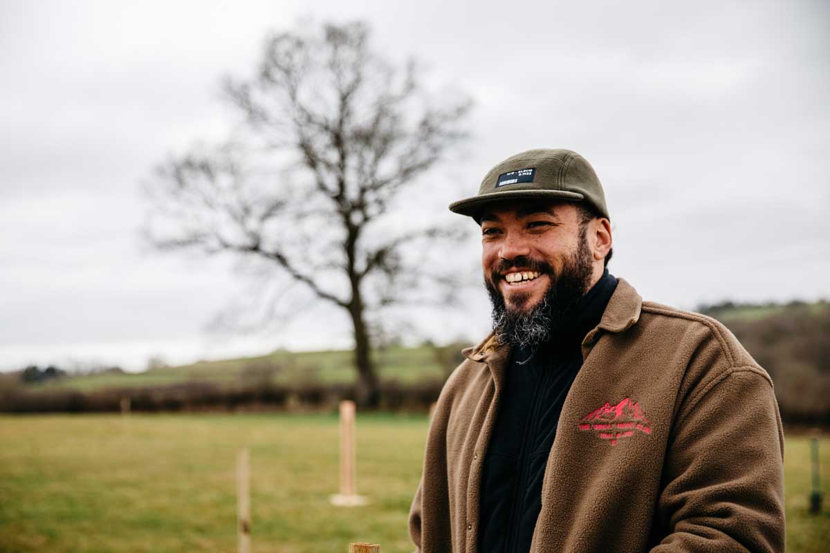 Man smiling at tree planting event.